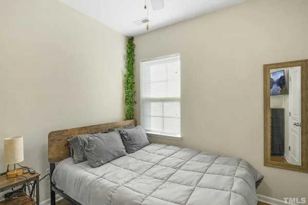 a large bed sitting in a bedroom next to a window