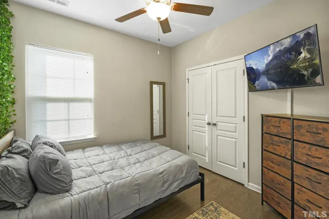 a bedroom with a bed and a painting on the wall