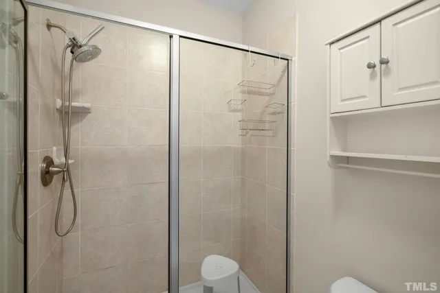 a bathroom with a shower and toilet