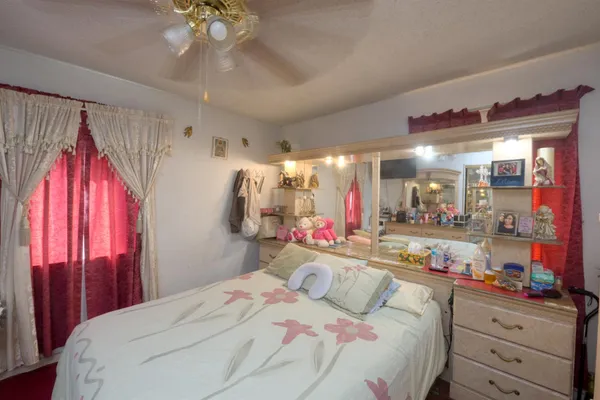 a bedroom with a bed and glass windows