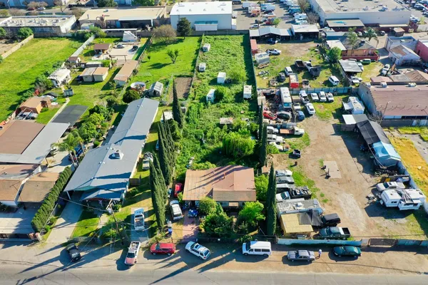 an aerial view of multiple houses with yard