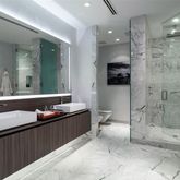 a bathroom with a double vanity sink toilet and shower