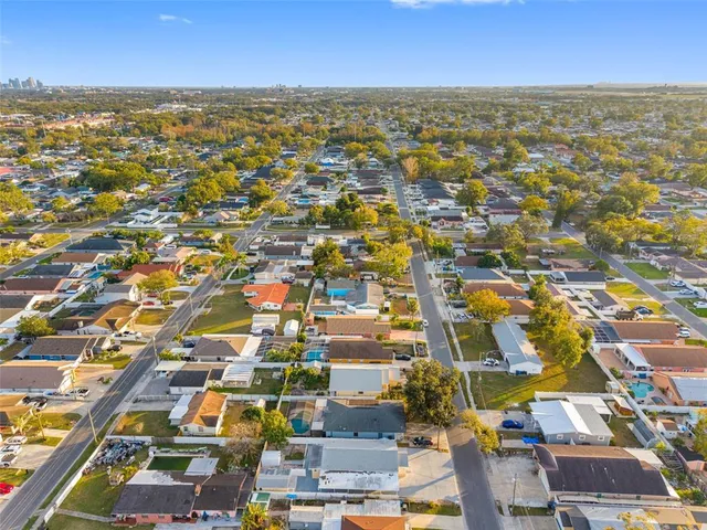 an aerial view of residential houses with city view