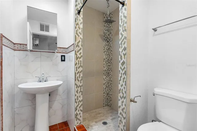 a kitchen with granite countertop white cabinets and a stove