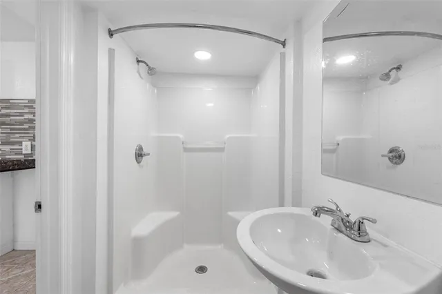 a kitchen with stainless steel appliances granite countertop a refrigerator a stove and a sink