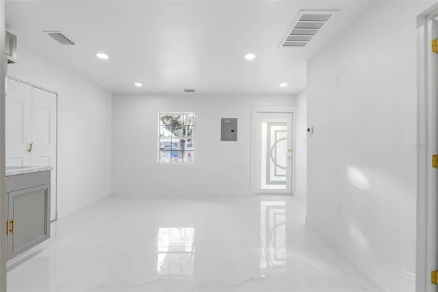 a view of a kitchen with a sink and a refrigerator