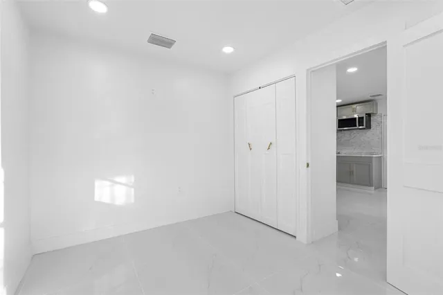 a kitchen with stainless steel appliances granite countertop a sink and a refrigerator