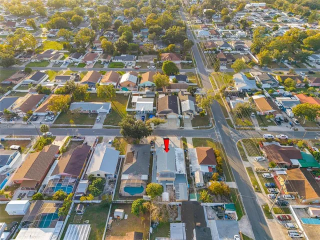 an aerial view of residential houses with yard