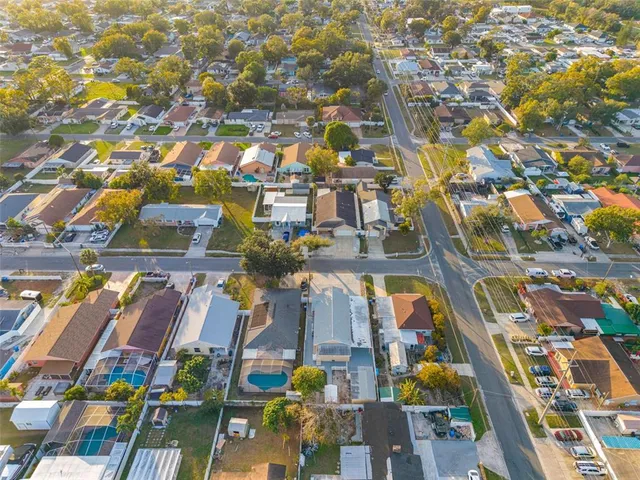 an aerial view of residential houses with city view