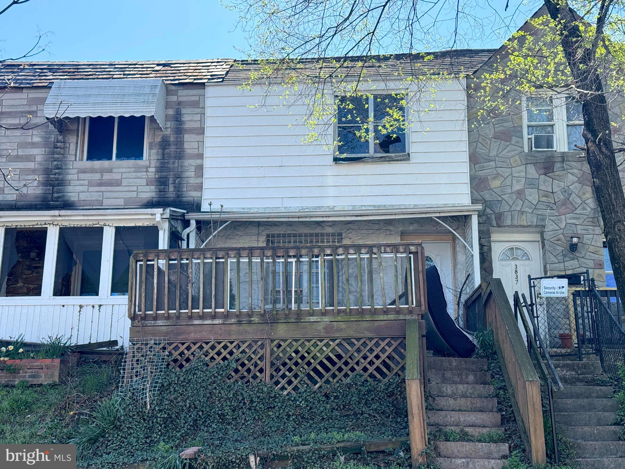 a view of a house with a small deck