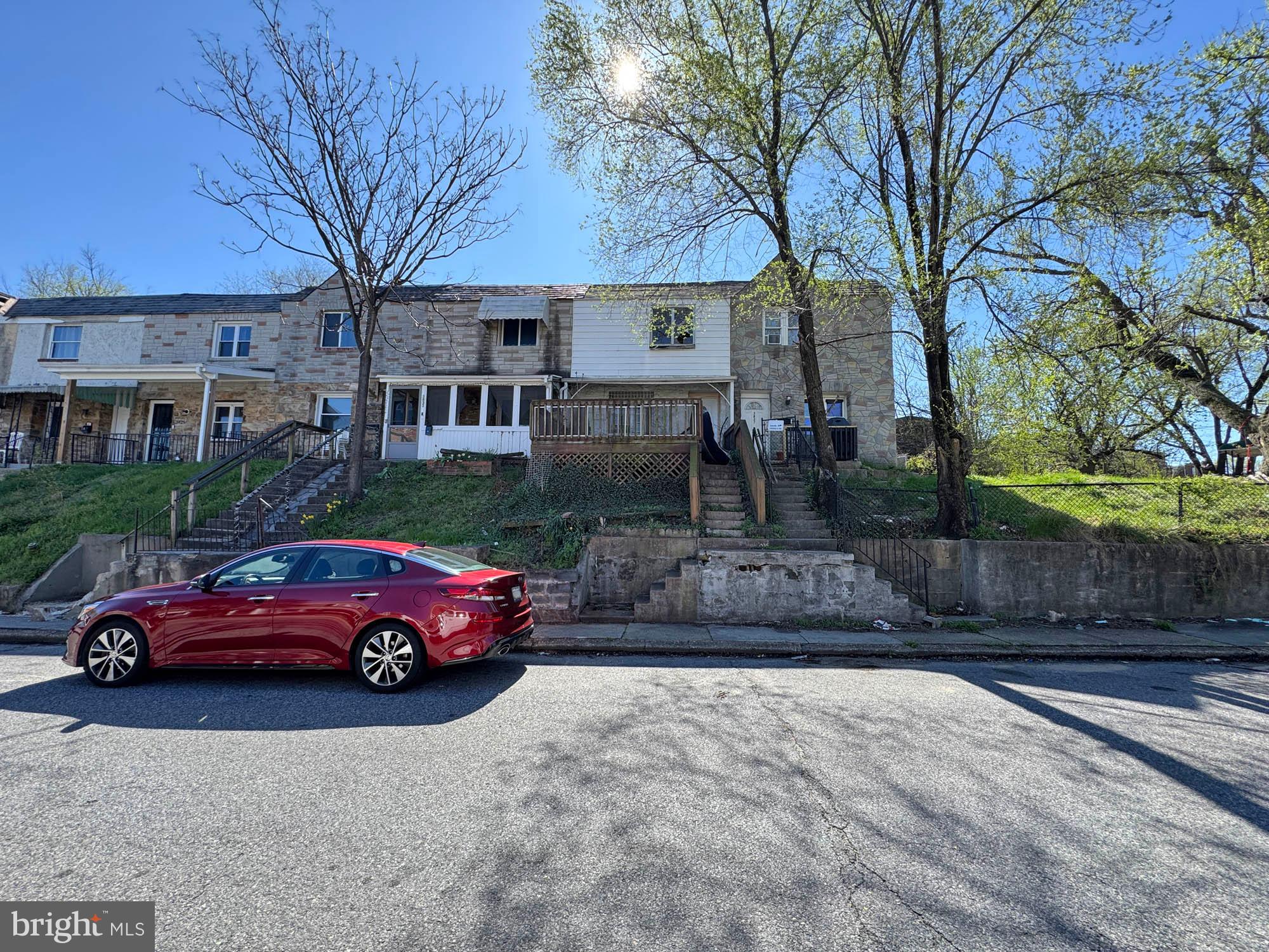 3835 8th Street Baltimore, MD 21225 - Photo 11 of 11 a front view of a house with a yard