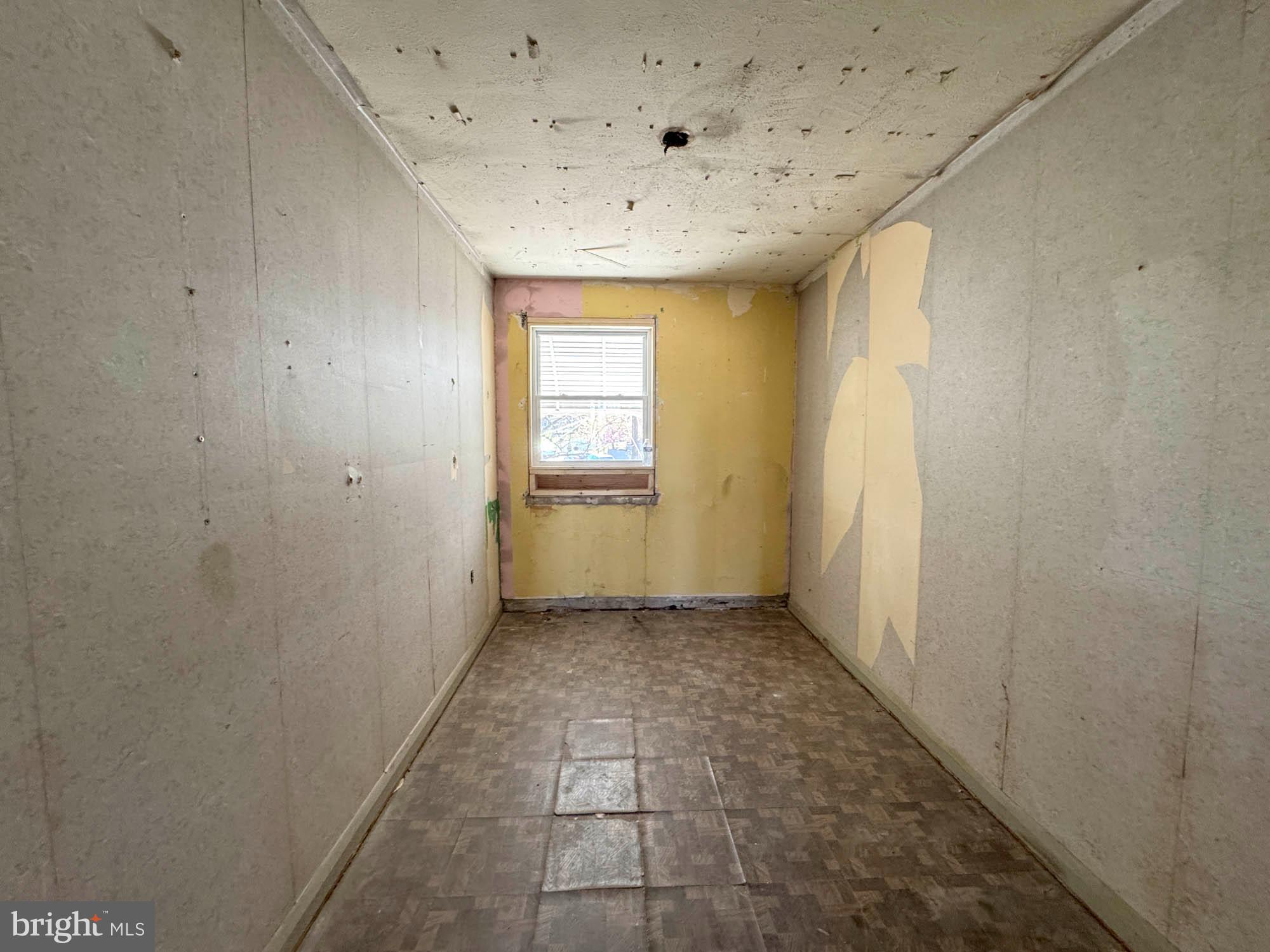 3835 8th Street Baltimore, MD 21225 - Photo 10 of 11 a view of a hallway with a window