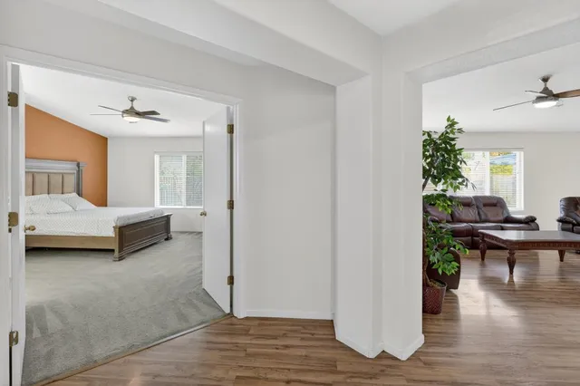 a living room with furniture and a wooden floor