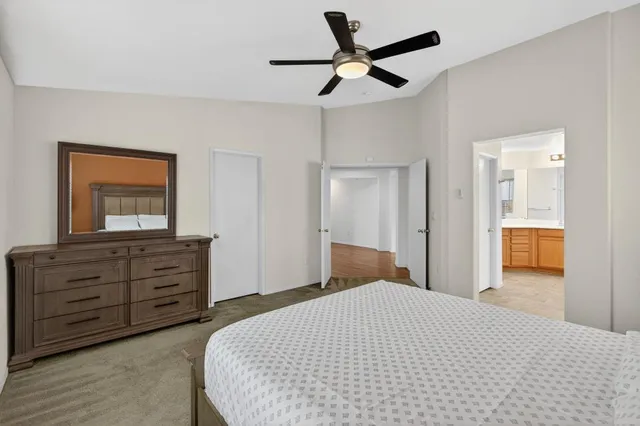 a bedroom with a bed and a dresser