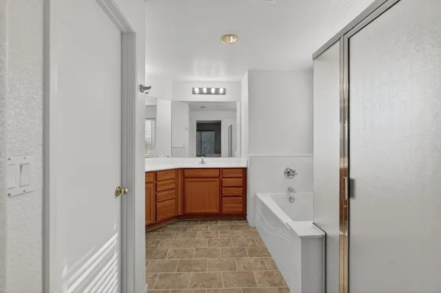 a bathroom with a sink vanity and mirror
