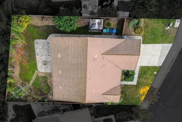 an aerial view of a house with a yard and potted plants