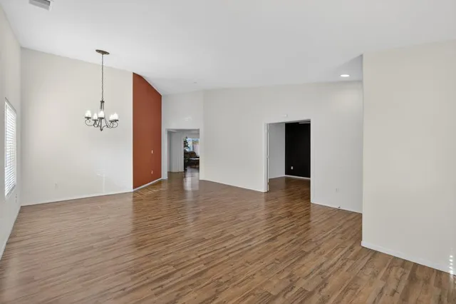 a view of a livingroom with wooden floor and staircase