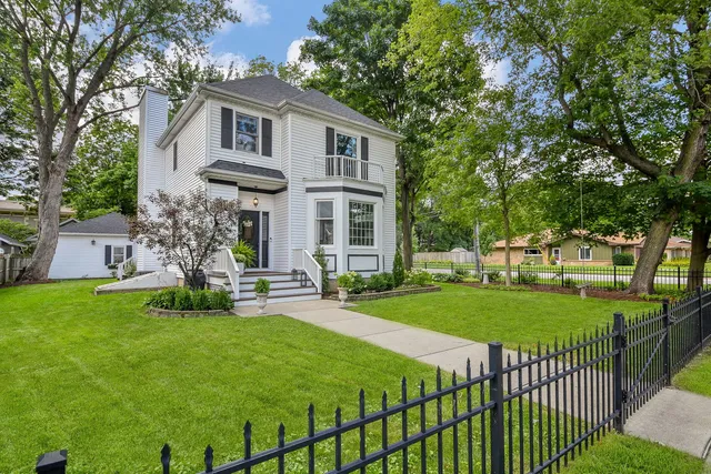 a front view of a house with a yard table and chairs