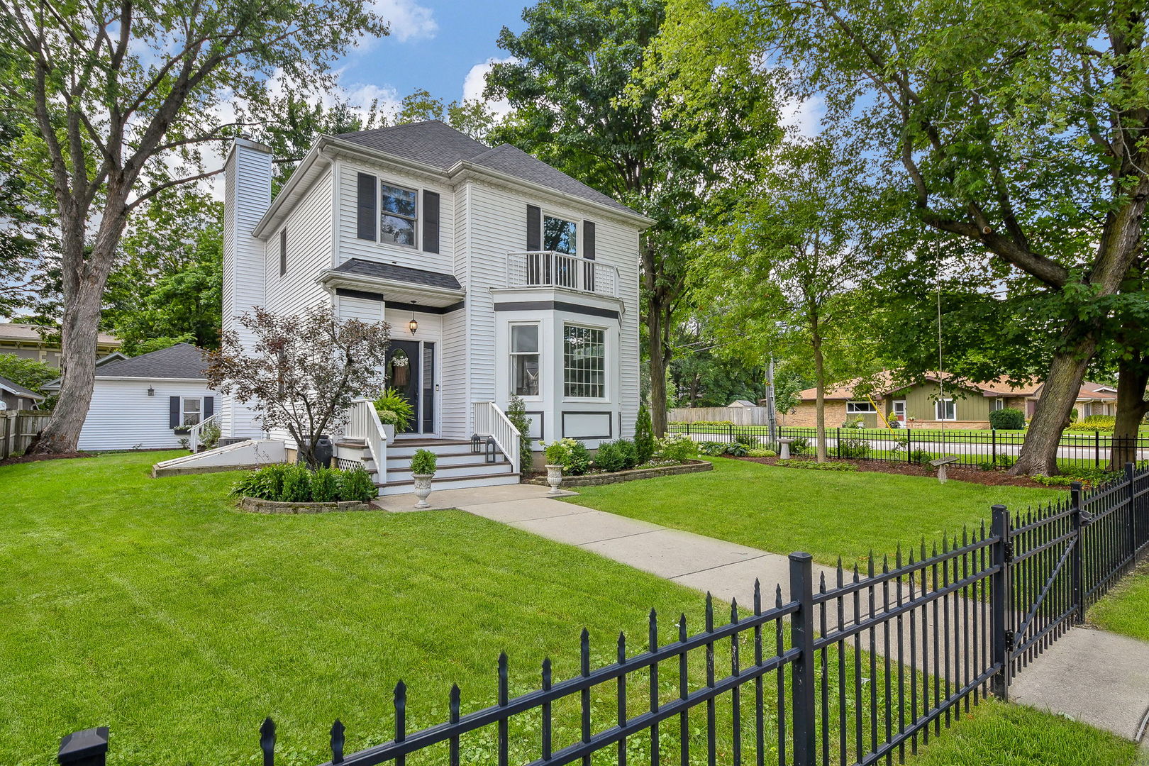 a front view of a house with a yard table and chairs