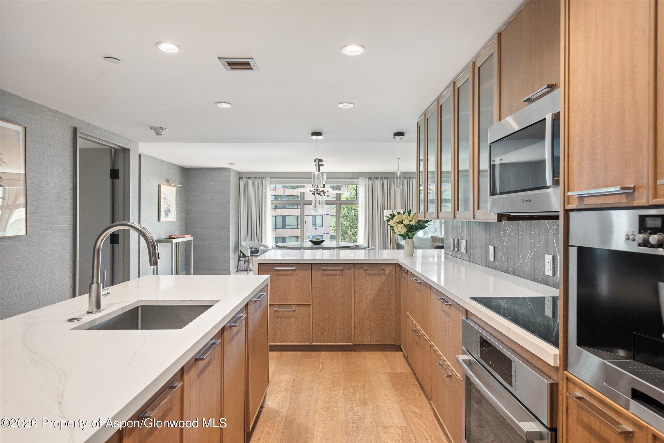 130 Wood Road, Unit 701/801 Snowmass Village, CO 81615 - Photo 11 of 41 a kitchen with stainless steel appliances a sink stove and cabinets