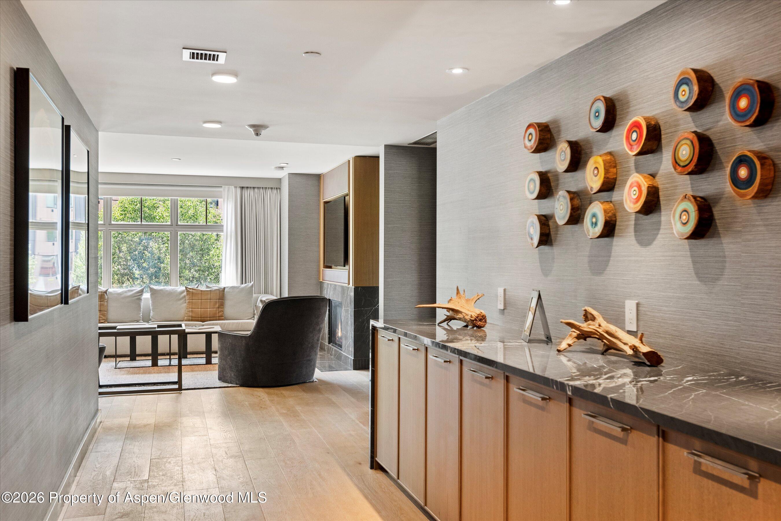 130 Wood Road, Unit 701/801 Snowmass Village, CO 81615 - Photo 14 of 41 a hallway with a large window and couch