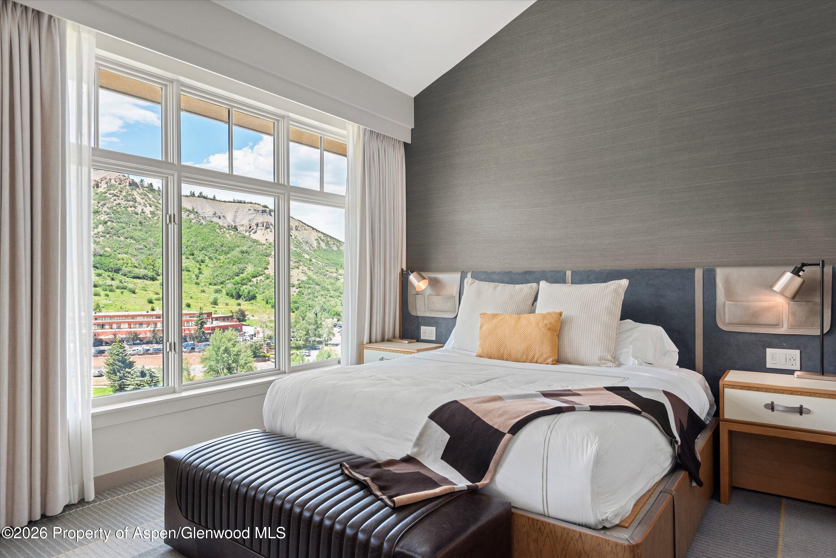 130 Wood Road, Unit 701/801 Snowmass Village, CO 81615 - Photo 18 of 41 a bedroom with a bed and a large window