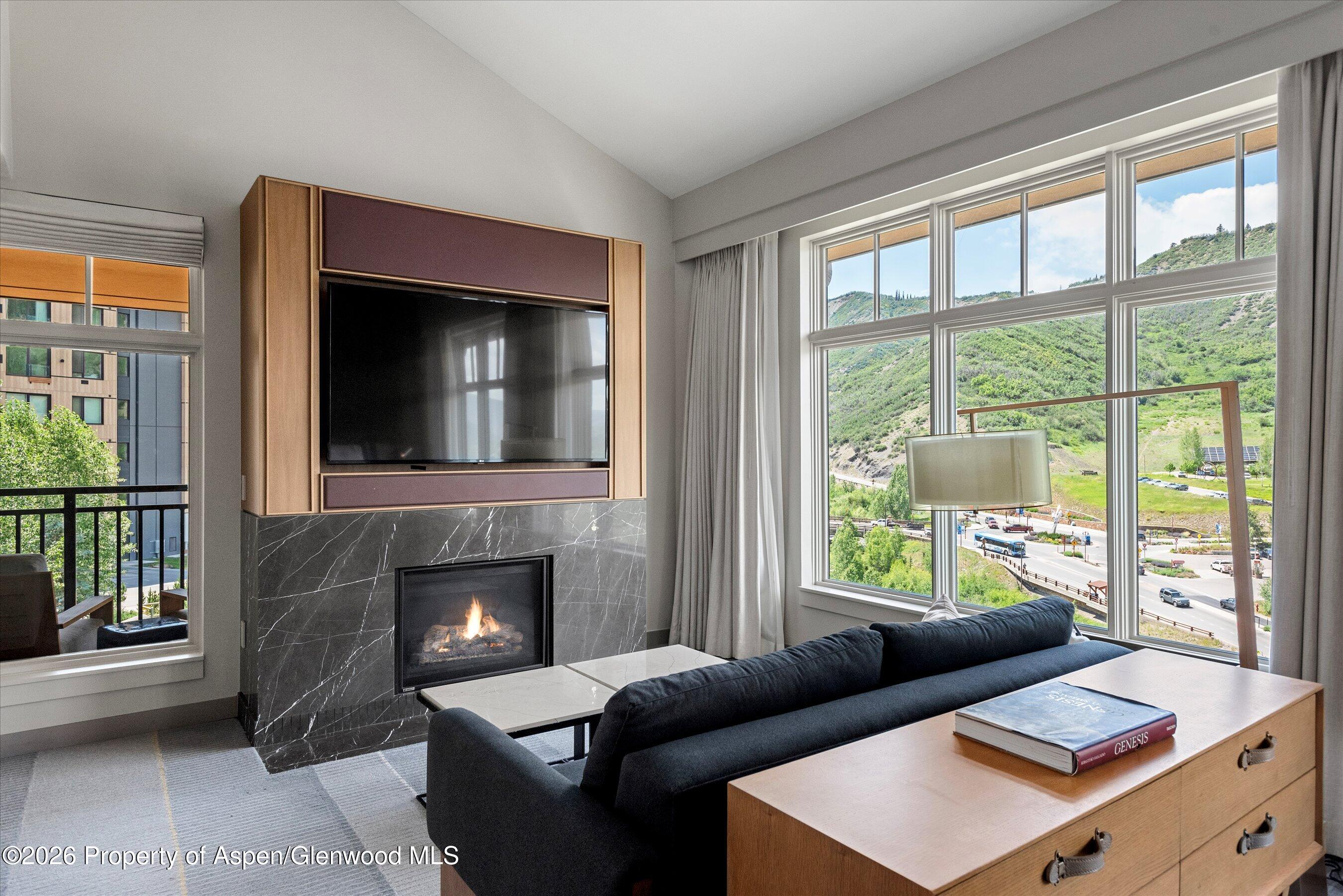 130 Wood Road, Unit 701/801 Snowmass Village, CO 81615 - Photo 19 of 41 a living room with furniture and a fireplace