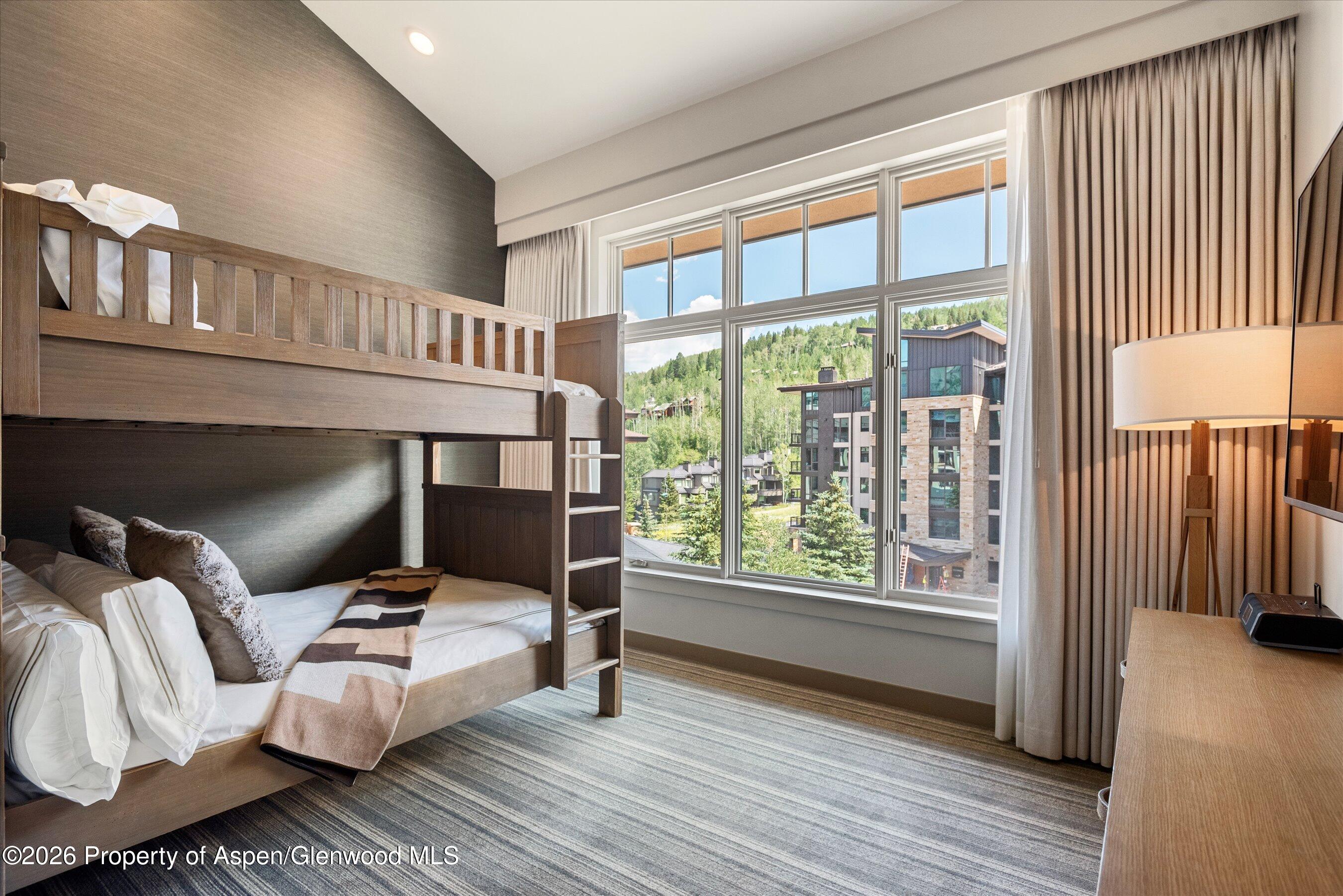 130 Wood Road, Unit 701/801 Snowmass Village, CO 81615 - Photo 22 of 41 a bedroom with furniture and a window