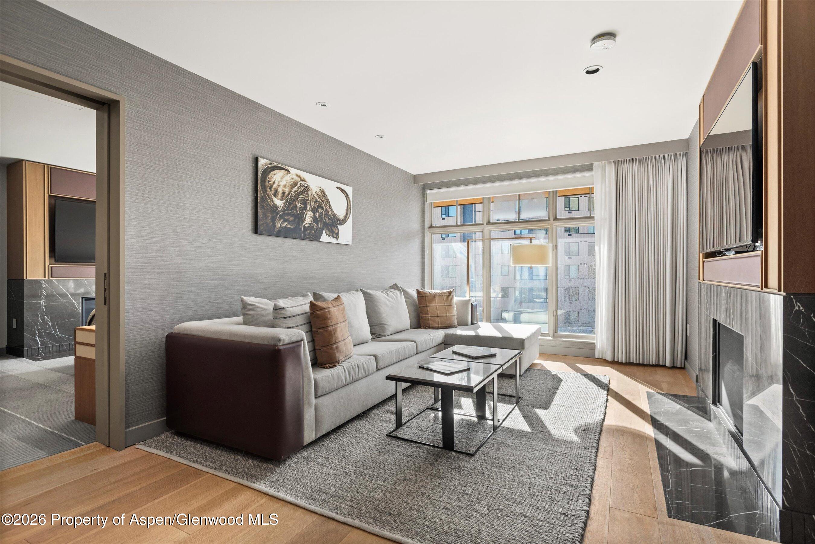 130 Wood Road, Unit 701/801 Snowmass Village, CO 81615 - Photo 24 of 41 a living room with furniture and a flat screen tv