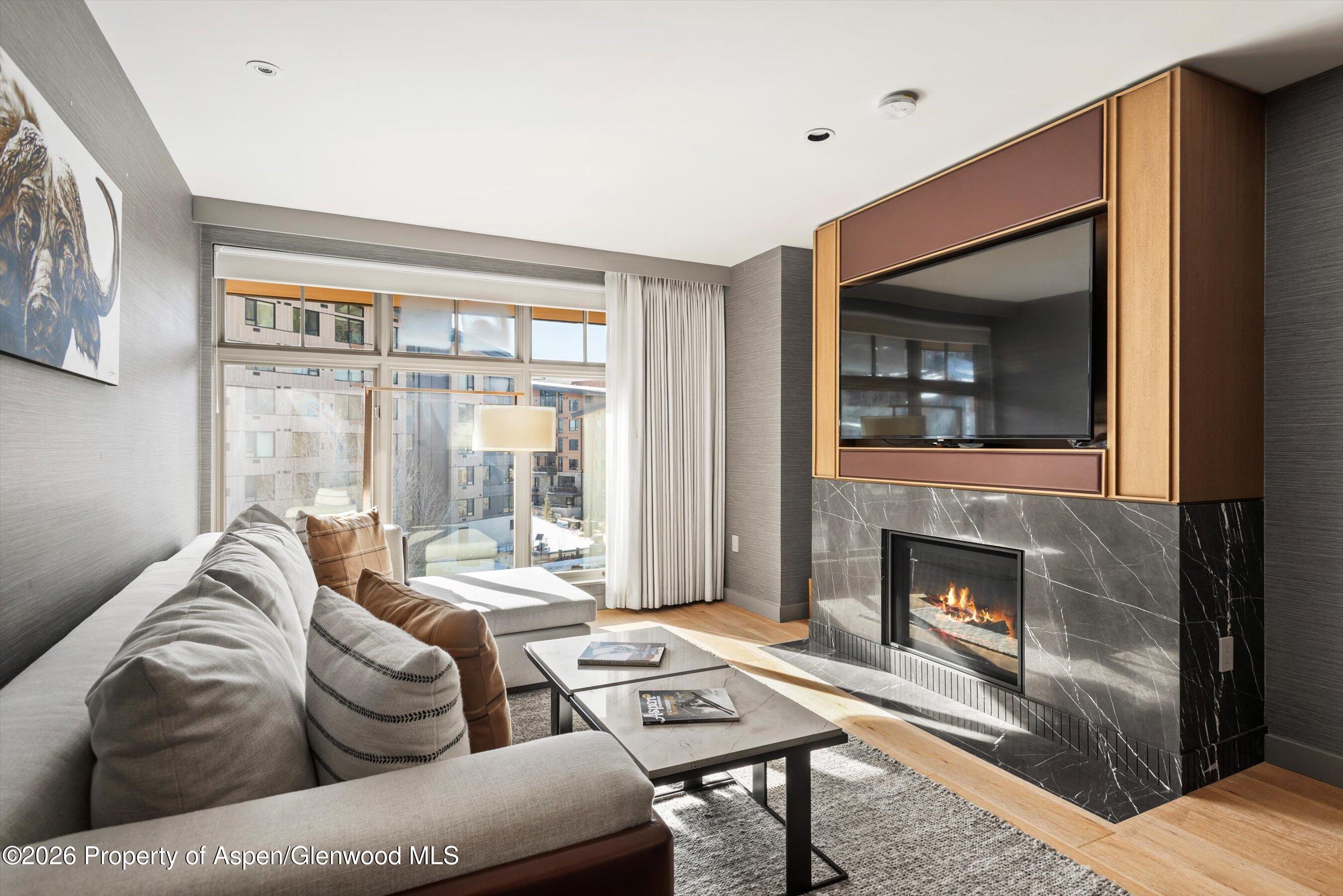 130 Wood Road, Unit 701/801 Snowmass Village, CO 81615 - Photo 25 of 41 a living room with furniture and a fireplace