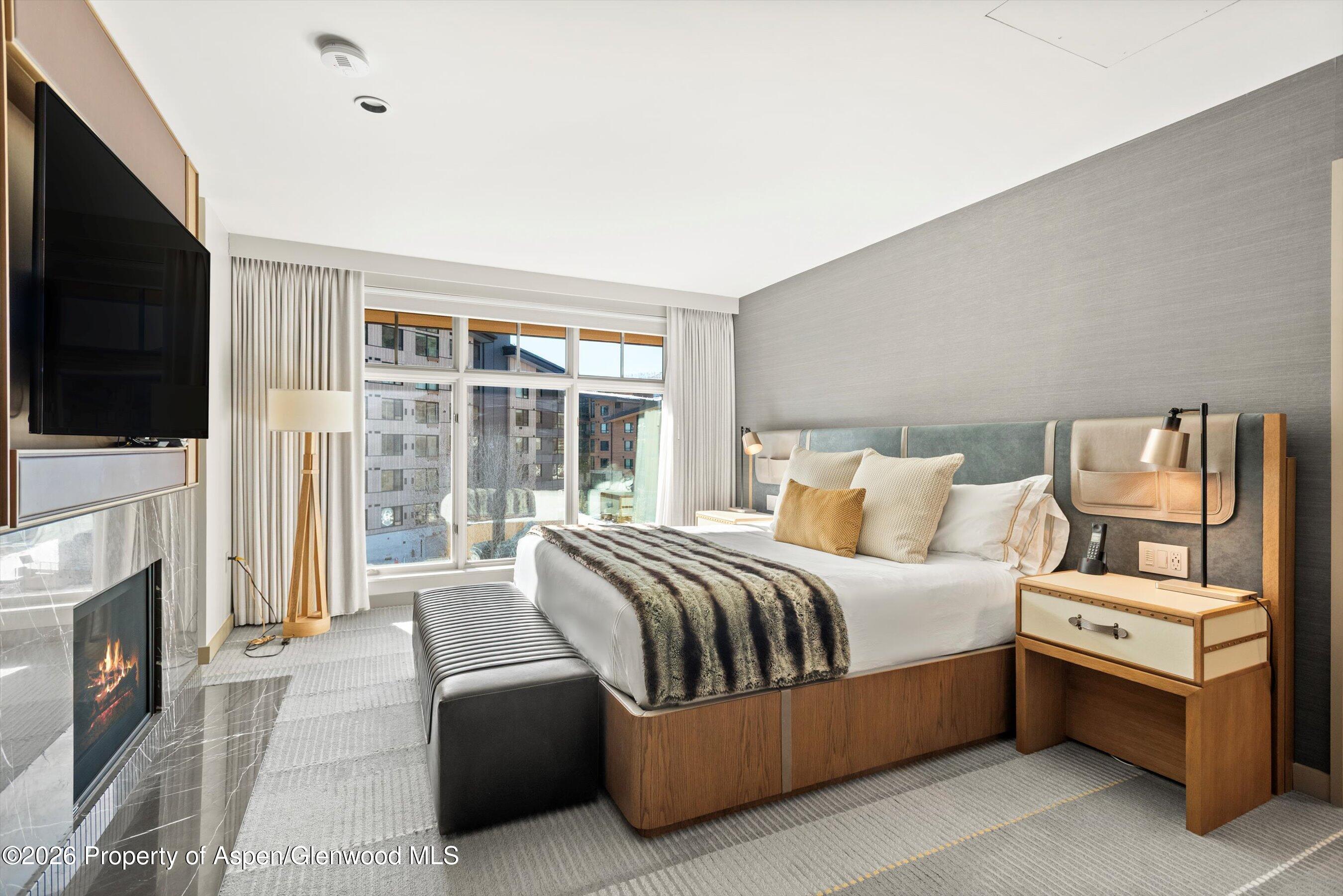 130 Wood Road, Unit 701/801 Snowmass Village, CO 81615 - Photo 31 of 41 a bedroom with a bed and a flat screen tv