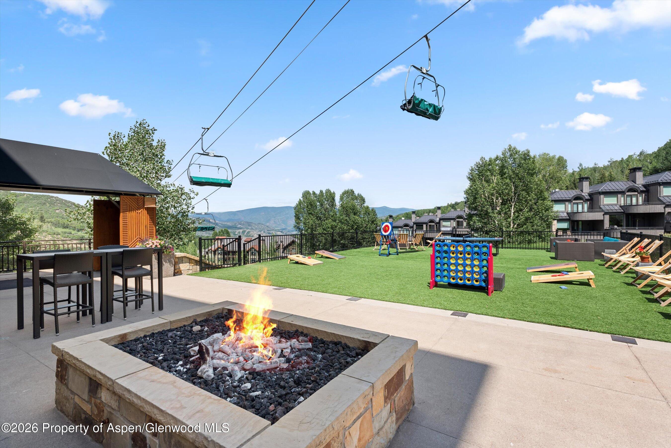 130 Wood Road, Unit 701/801 Snowmass Village, CO 81615 - Photo 35 of 41 a view of a chairs and table in backyard