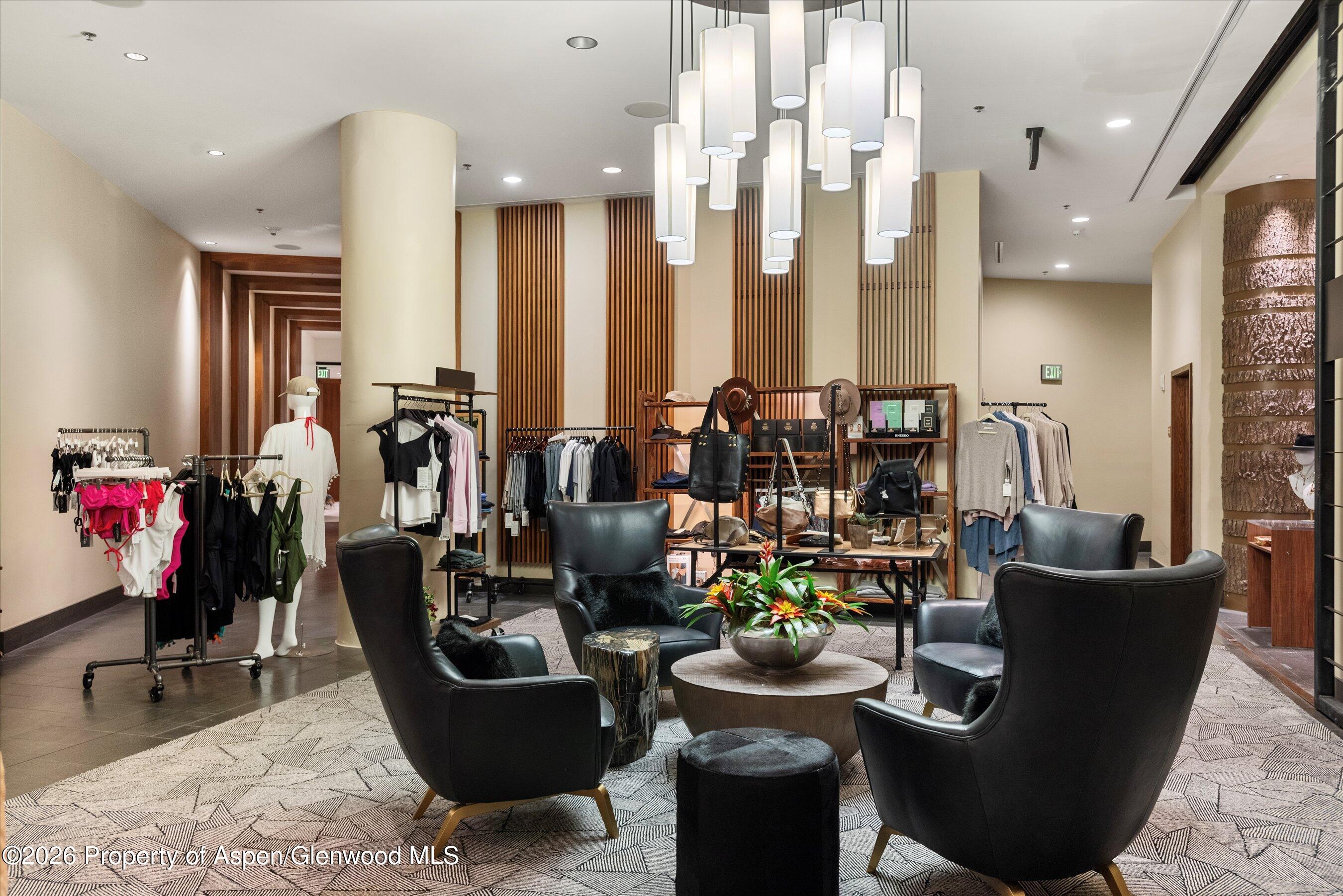 130 Wood Road, Unit 701/801 Snowmass Village, CO 81615 - Photo 38 of 41 a living room with couches and kitchen view with wooden floor