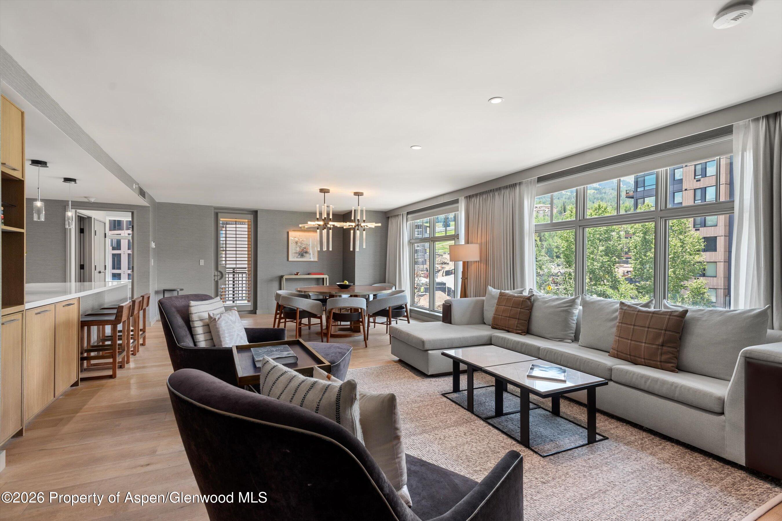 130 Wood Road, Unit 701/801 Snowmass Village, CO 81615 - Photo 4 of 41 a living room with furniture and a large window