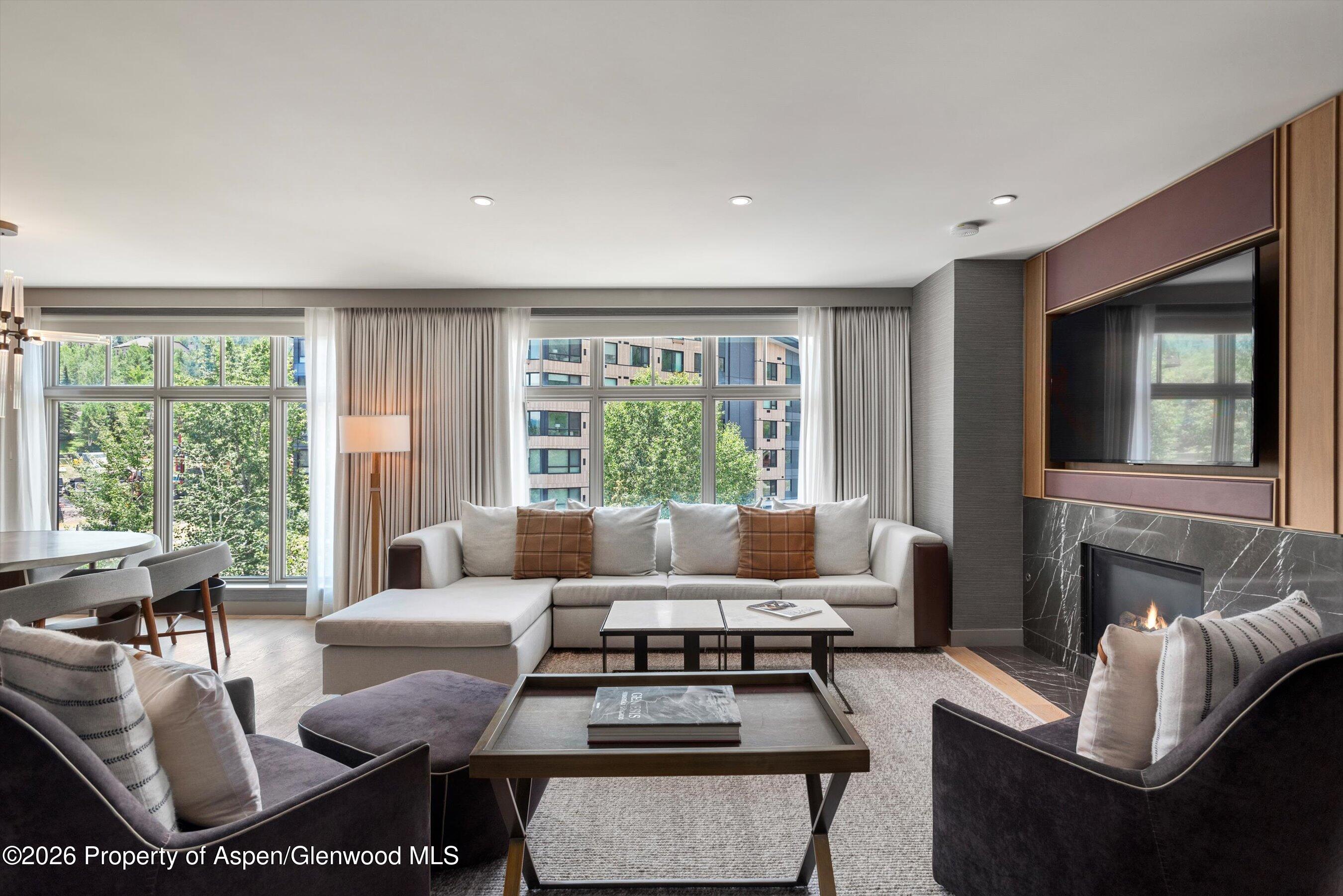 130 Wood Road, Unit 701/801 Snowmass Village, CO 81615 - Photo 5 of 41 a living room with furniture and a large window