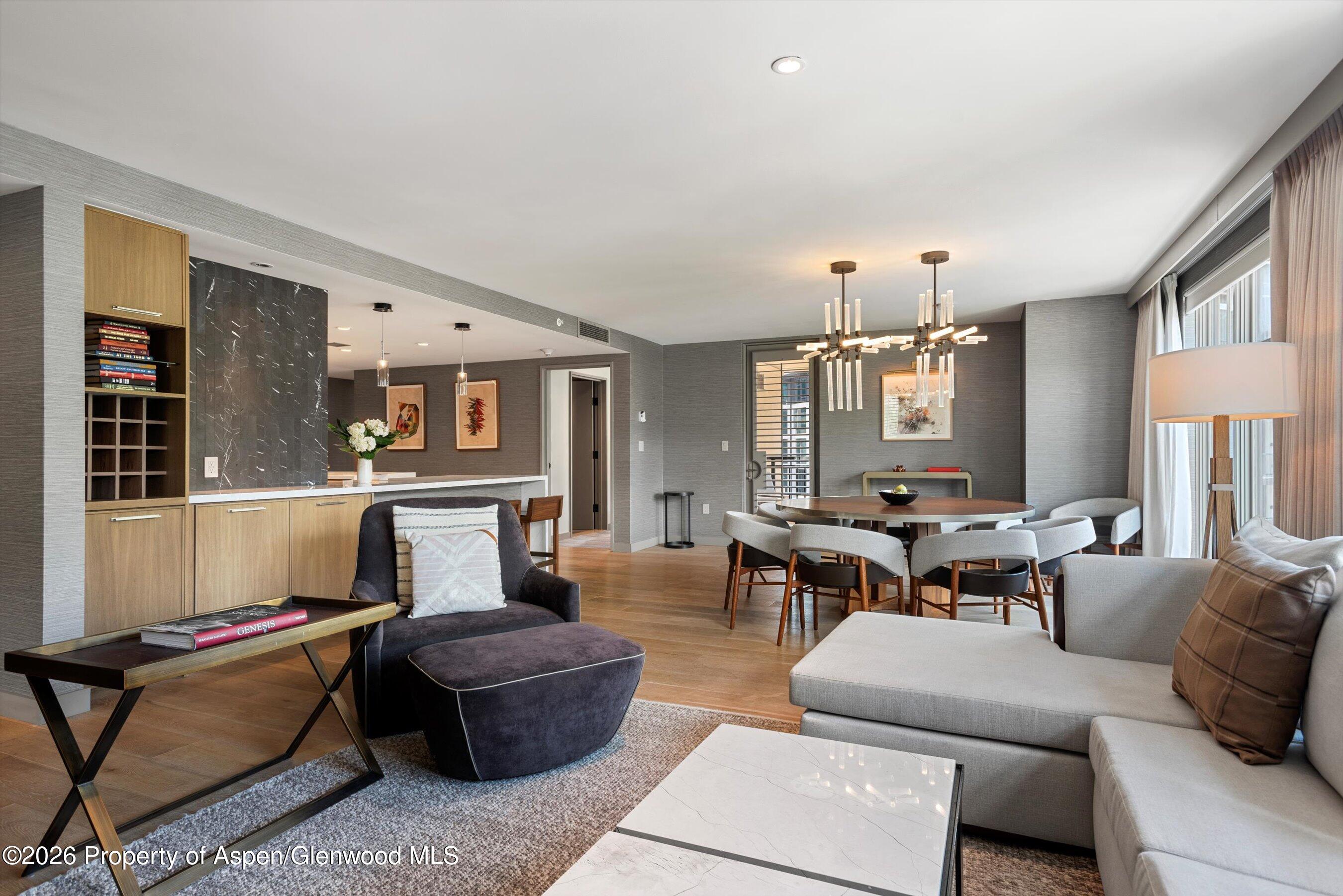 130 Wood Road, Unit 701/801 Snowmass Village, CO 81615 - Photo 6 of 41 a living room with furniture and wooden floor