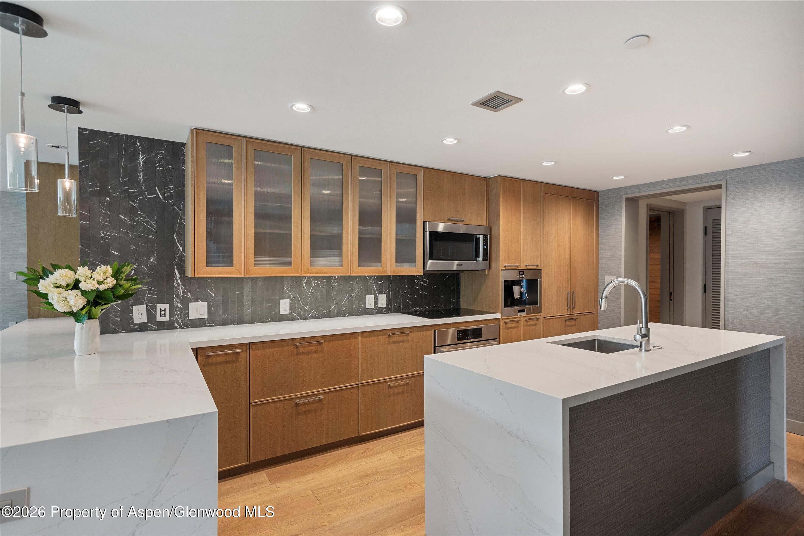 130 Wood Road, Unit 701/801 Snowmass Village, CO 81615 - Photo 9 of 41 a kitchen that has a sink and a stove in it