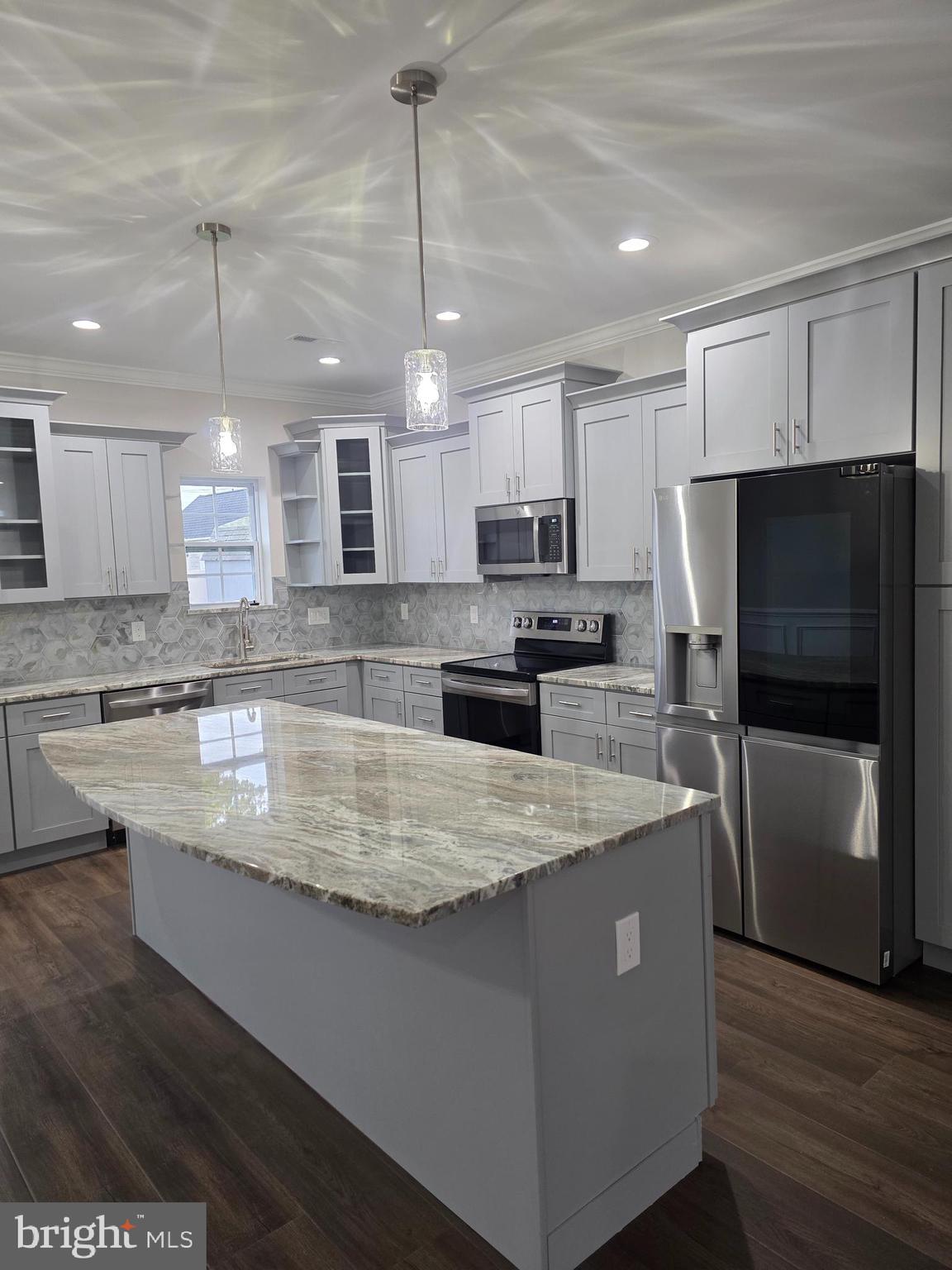 110 Neshaminy Road Croydon, PA 19021 - Photo 7 of 21 a large kitchen with kitchen island a large counter top stainless steel appliances and cabinets