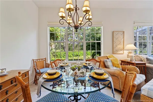 a living room with patio furniture and a large window