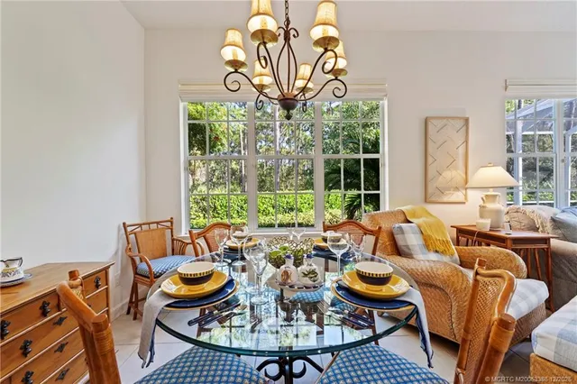 a living room with patio furniture and a large window