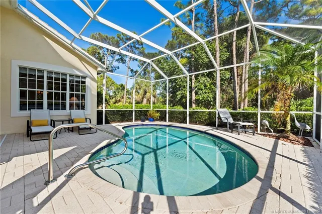 a view of a swimming pool with a patio and garden view