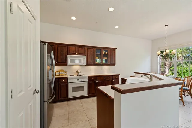a kitchen that has a sink and a stove in it