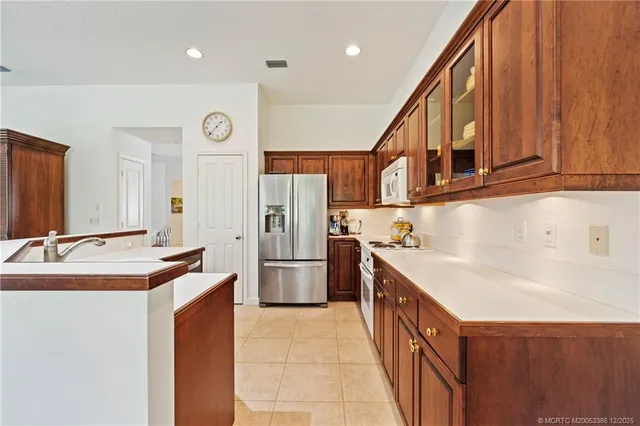 a kitchen with refrigerator cabinets and a sink