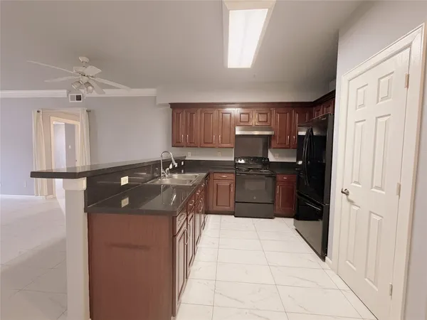 a kitchen with stainless steel appliances granite countertop a sink and cabinets