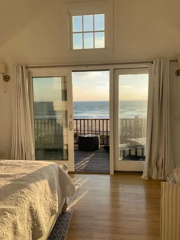 a bedroom with a bed and glass door