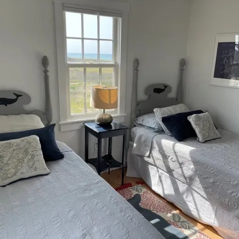 a bedroom with a bed and window