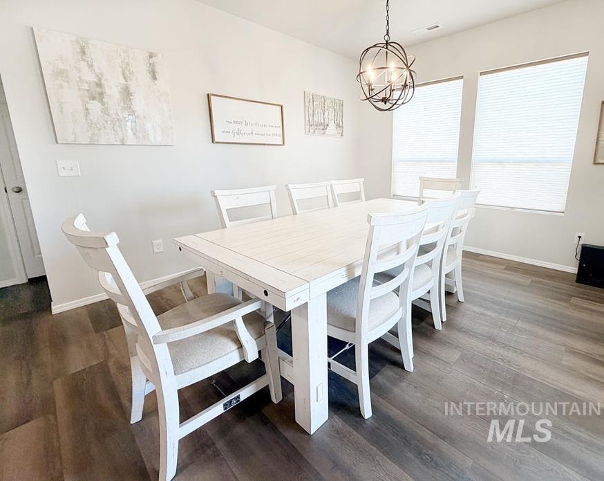 13694 Oliver Street Caldwell, ID 83607 - Photo 11 of 28 Dining area with dark wood-style floors and suspended lighting