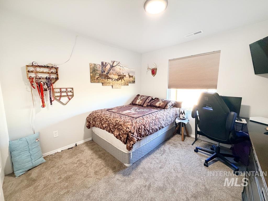 13694 Oliver Street Caldwell, ID 83607 - Photo 14 of 28 Bedroom featuring a desk and light carpet