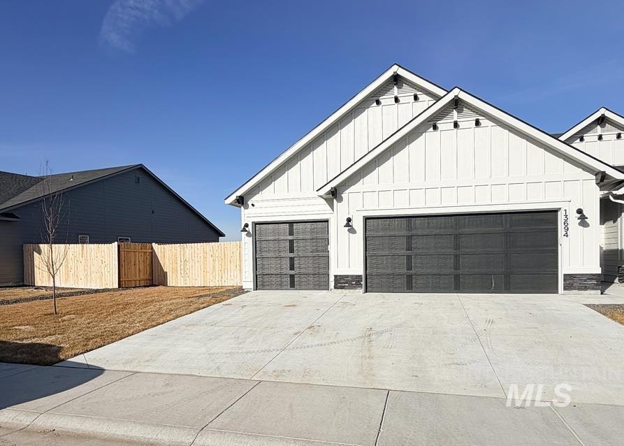 13694 Oliver Street Caldwell, ID 83607 - Photo 2 of 28 Modern farmhouse with board and batten siding, stone siding, driveway, and a garage