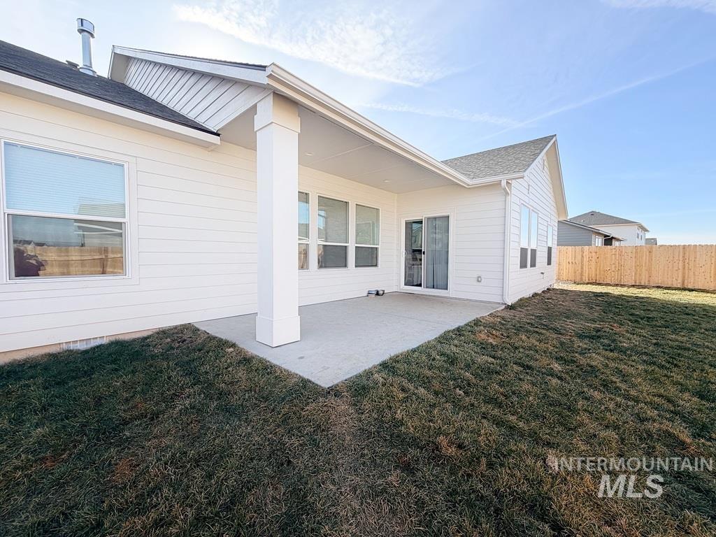13694 Oliver Street Caldwell, ID 83607 - Photo 28 of 28 Back of property with a patio and a shingled roof